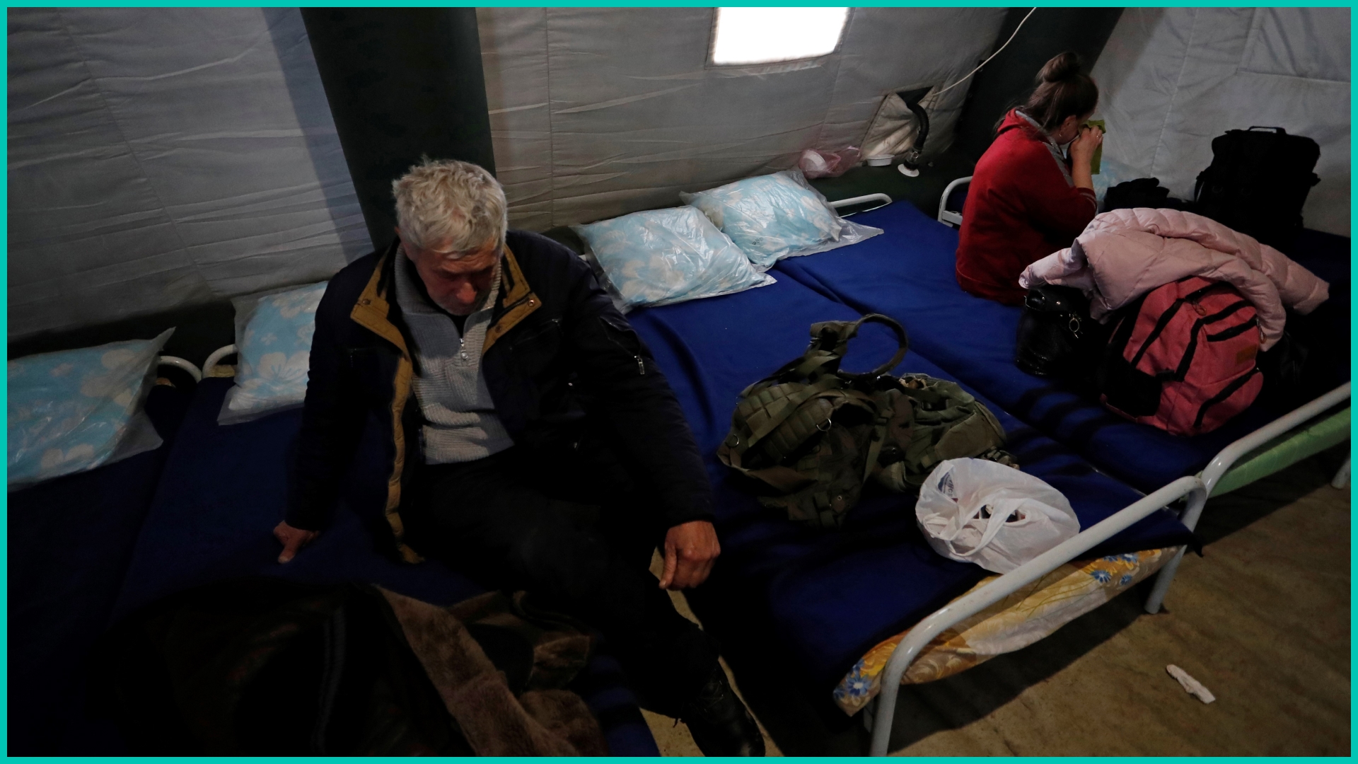 People evacuated from Mariupol rest at a settlement site in Donetsk