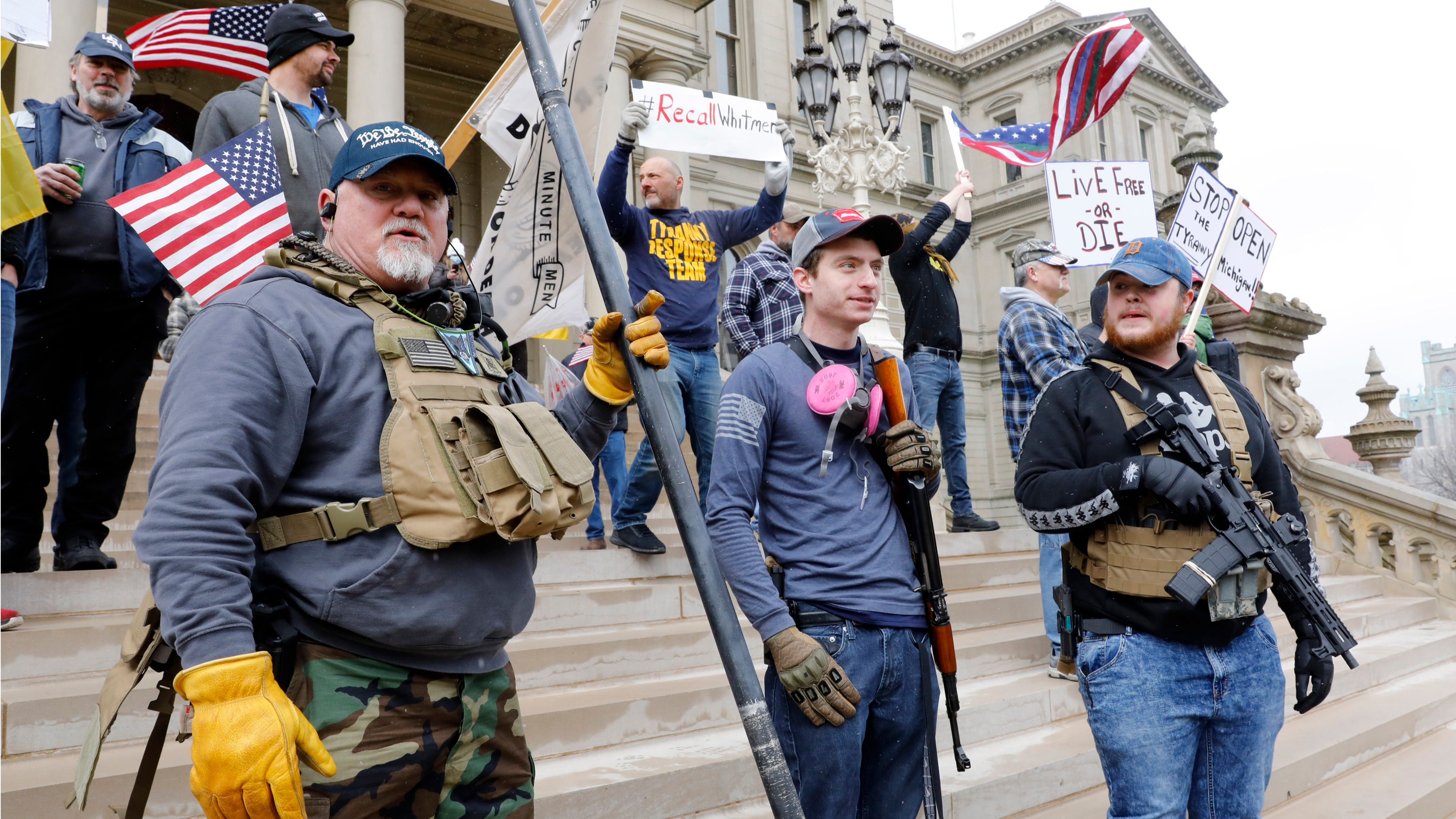 People take part in a protest for "Michiganders Against Excessive Quarantine" at the Michigan State Capitol in Lansing, Michigan on April 15, 2020