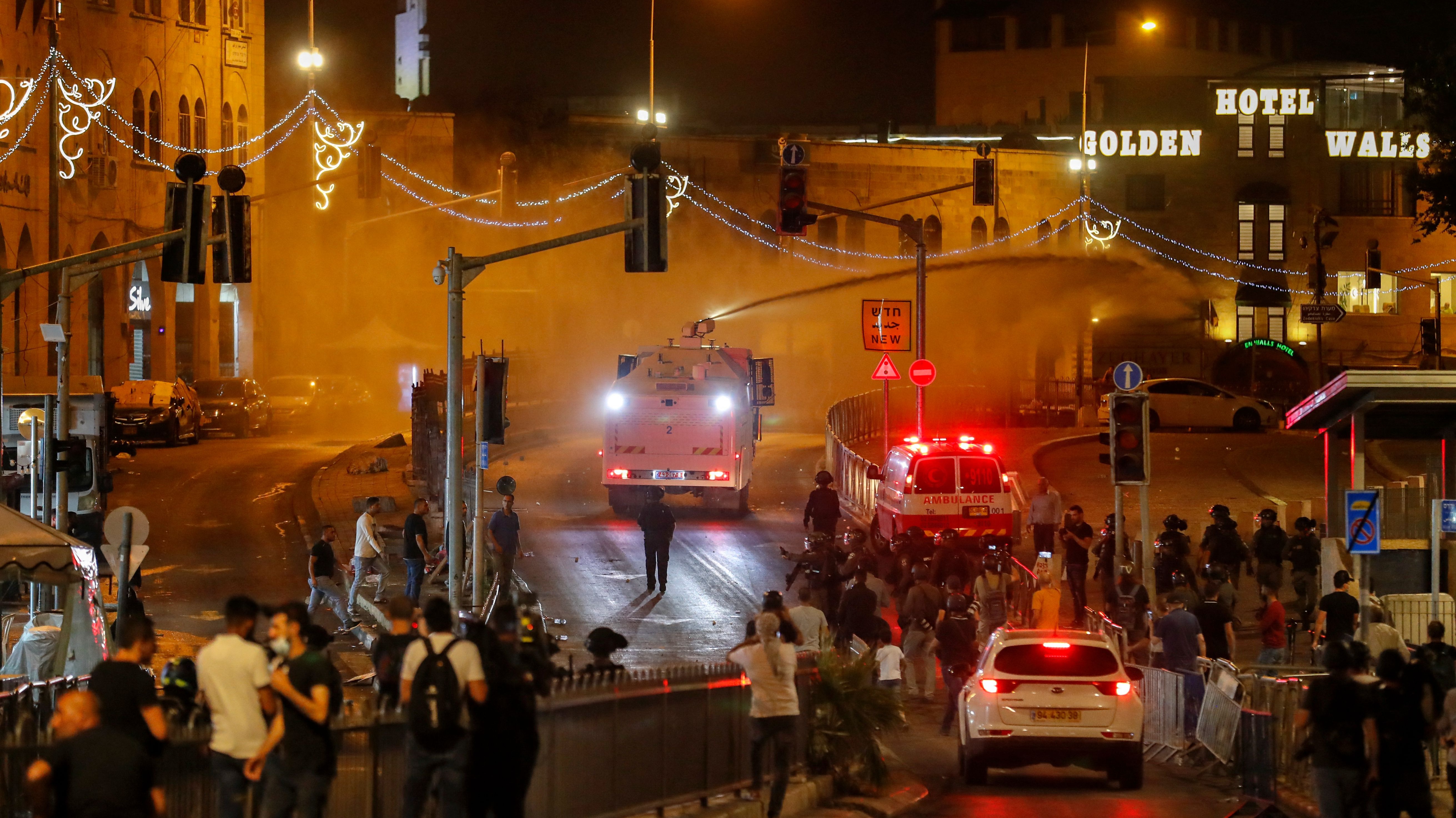 Israeli security forces fire a water cannon during clashes with Palestinian protesters outside the Damascus Gate in Jerusalem's Old City on May 9, 2021.