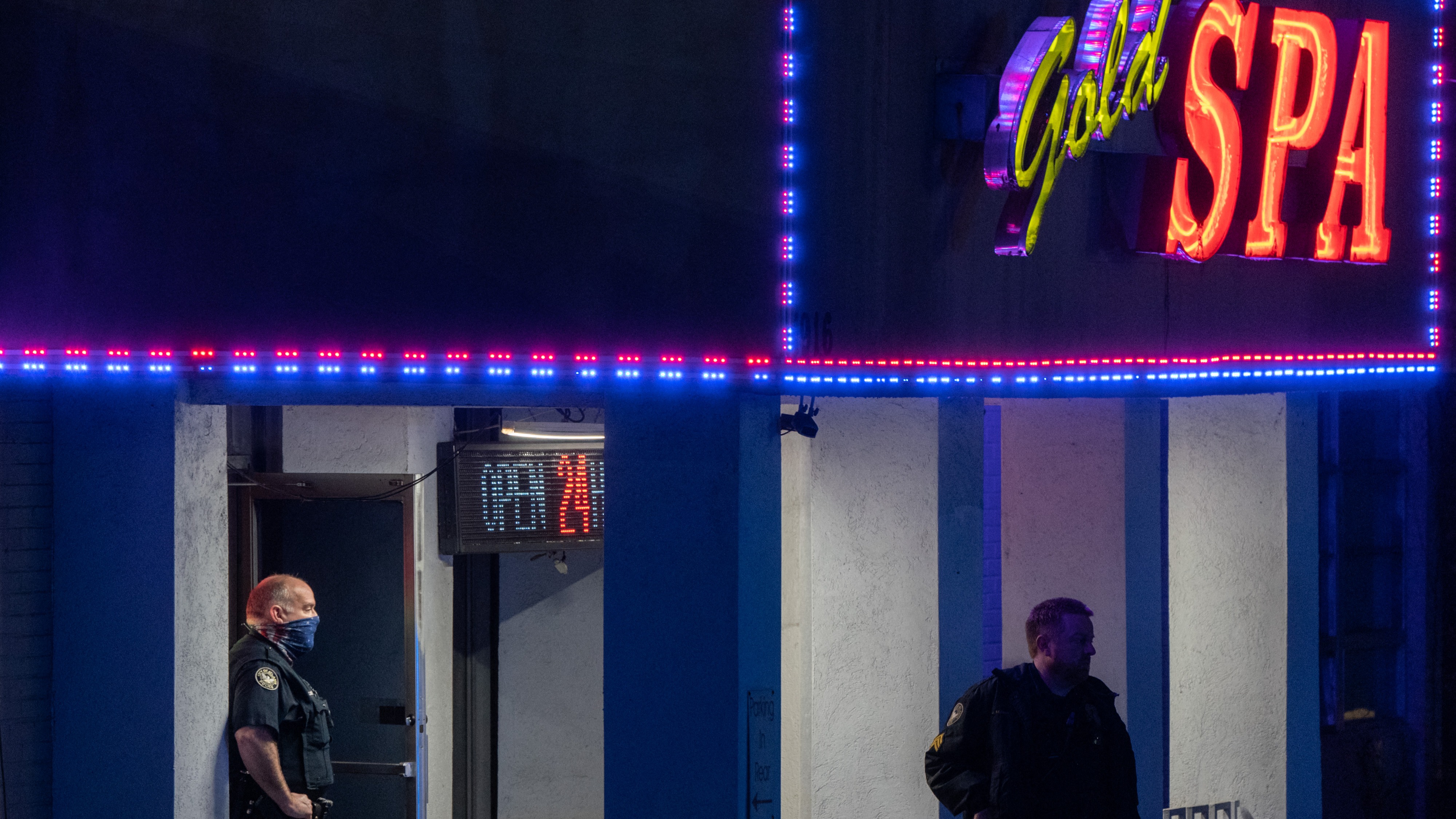 Police officers are seen outside a massage parlor where three people were shot and killed on March 16, 2021, in Atlanta, Georgia.